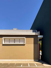 Low angle view of building against clear blue sky