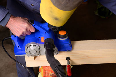Cropped image of carpenter working in workshop