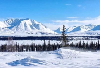 Scenic view of snowcapped landscape and mountains against sky