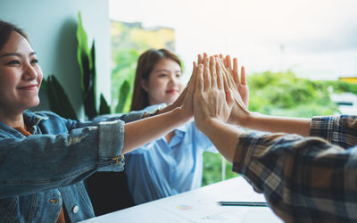 Close-up of business colleagues working at office