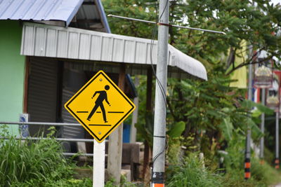 Road sign against trees