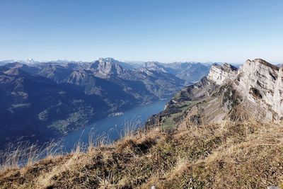 Scenic view of mountains against clear blue sky