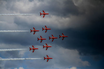 Low angle view of airshow against sky