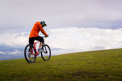 Man riding bicycle on field