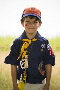 Portrait of cute smiling boy standing on land