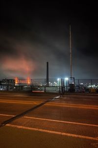 Illuminated city against sky at night