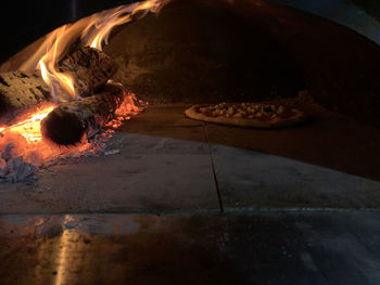 The wood-fired oven in the first phase of cooking a neapolitan pizza