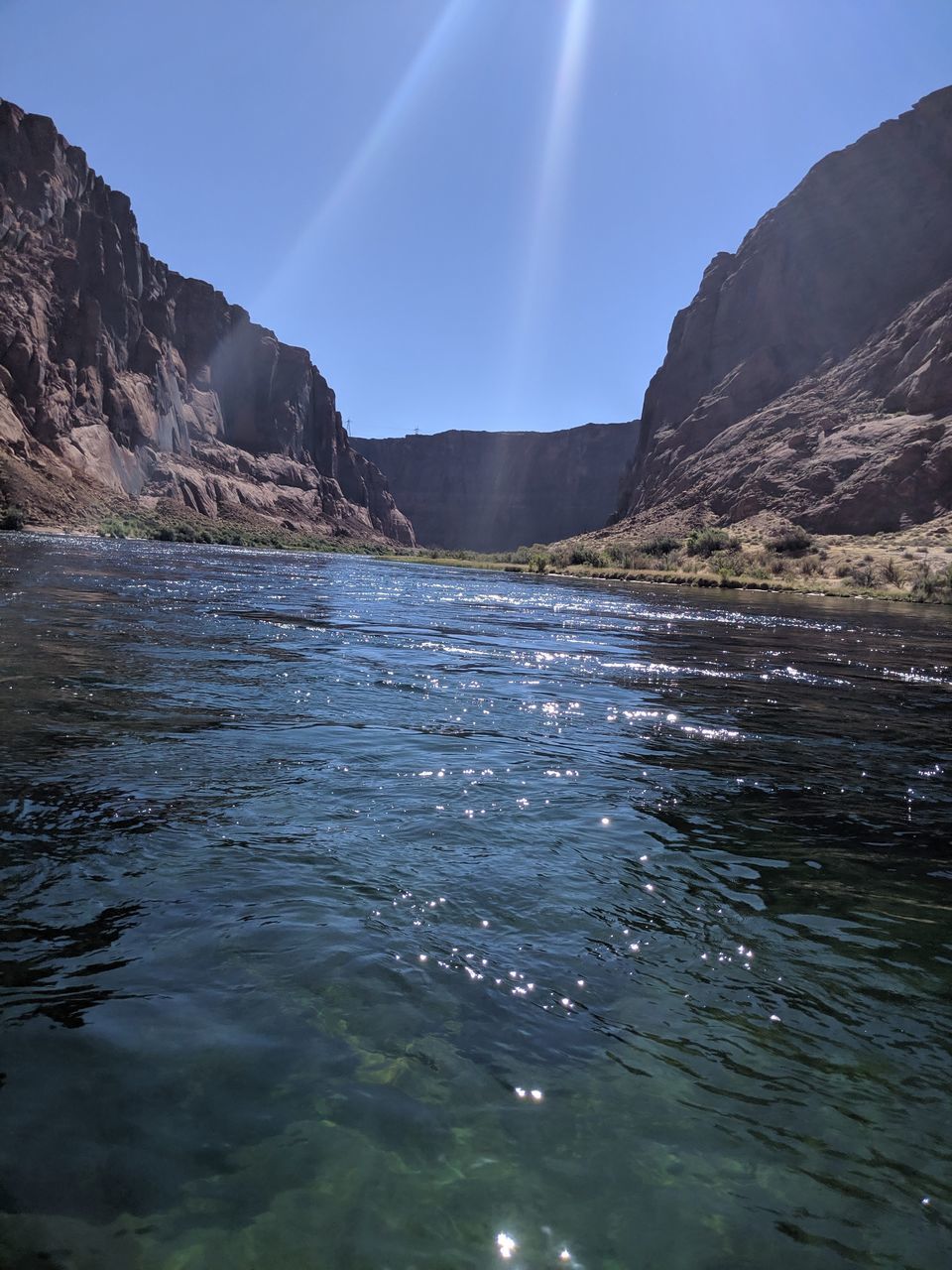 water, mountain, environment, scenics - nature, sky, landscape, beauty in nature, nature, sea, land, travel destinations, reflection, travel, no people, blue, mountain range, outdoors, coast, tranquility, rock, tourism, tranquil scene, clear sky, cloud, sunlight, body of water, sunbeam, sun