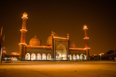 Illuminated building against sky at night