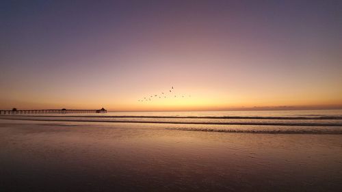 Scenic view of sea against clear sky during sunset