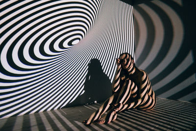 Woman sitting against wall