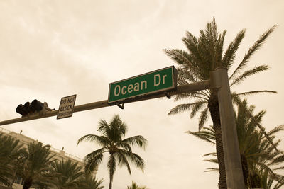 Low angle view of road sign against sky