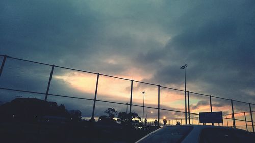 Road against cloudy sky at sunset