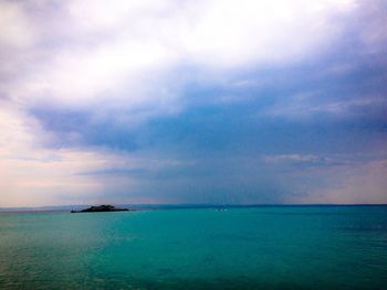 Scenic view of sea against cloudy sky