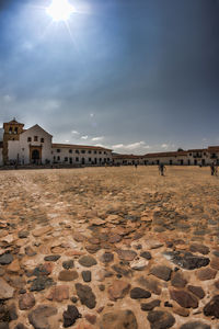 Cobblestone pathway with church against sky