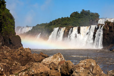 Scenic view of waterfall against rocks