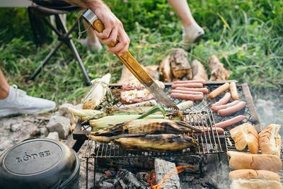 Man preparing food on barbecue grill