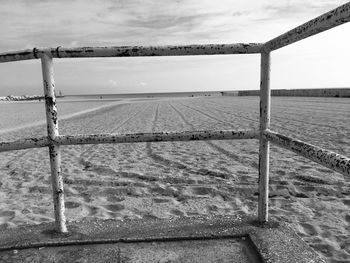 Fence on field against sky