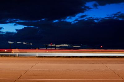 Airplane on runway against sky at night