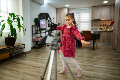Side view of young woman standing in gym