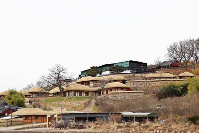 Houses in city against clear sky