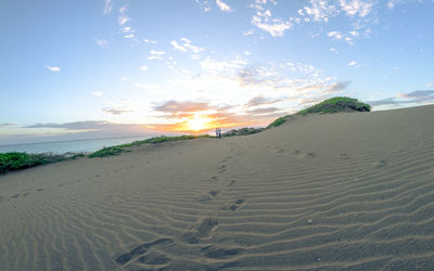 Scenic view of beach against sky during sunset