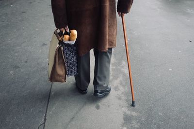 Low section of man walking on footpath