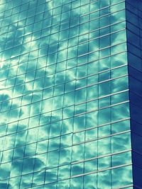 Low angle view of office building against blue sky