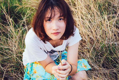 Portrait of a girl sitting on field