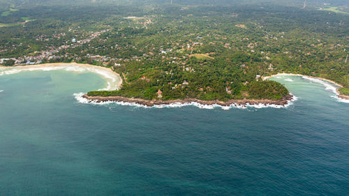 Aerial view of hiriketiya beach in a lagoon among palm trees. sri lanka.