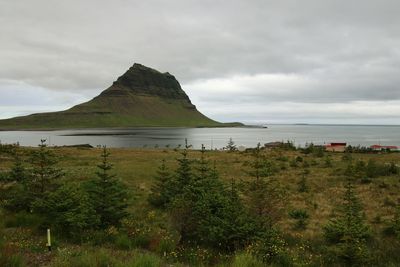 Scenic view of sea and mountains against sky