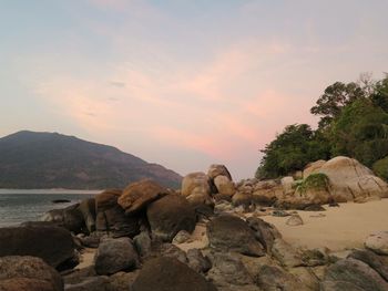 Scenic view of rocks and mountains against sky