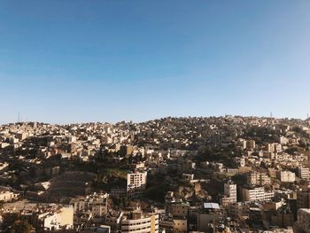 High angle view of townscape against clear blue sky