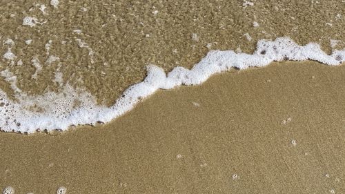High angle view of wet sand on beach