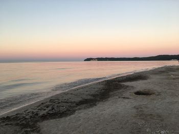 Scenic view of sea against clear sky during sunset