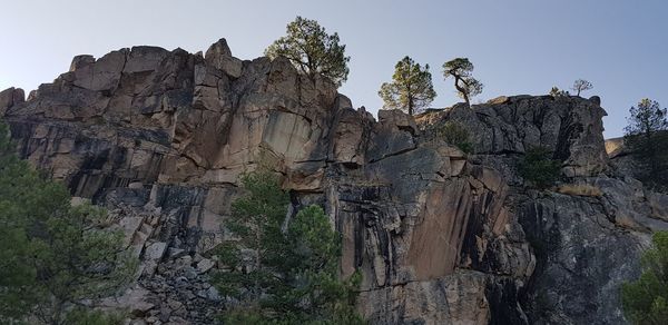 Low angle view of rocky mountain against sky