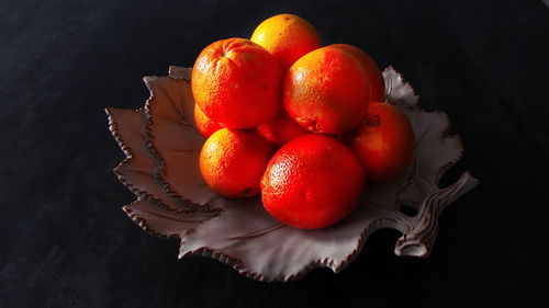 High angle view of strawberries on table against black background