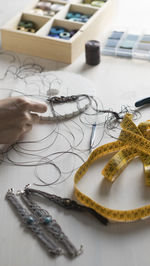 High angle view of woman working with thread on table