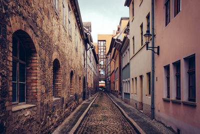 Narrow street amidst buildings in city