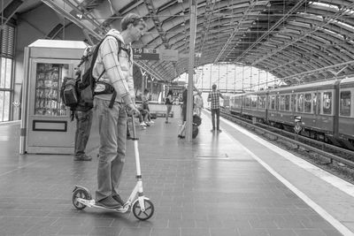 People walking on railroad station platform