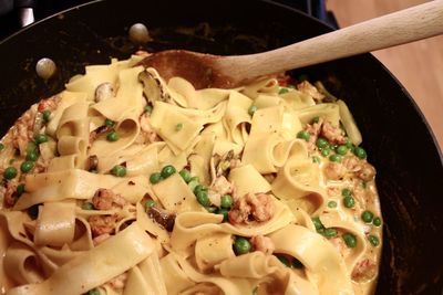 Close-up of pasta with wooden spoon in cooking pan