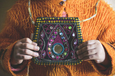 Woman holding embroidered bag