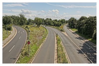 Panoramic view of road amidst plants against sky