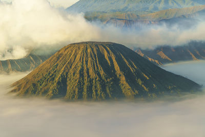 Smoke emitting from volcanic mountain against sky