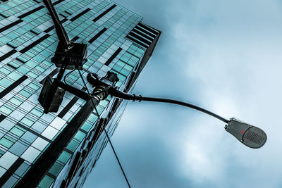 Low angle view of street light against modern building