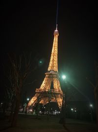 Illuminated tower against sky at night