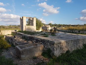 Old ruin building against cloudy sky