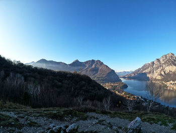 Scenic view of mountains against clear blue sky