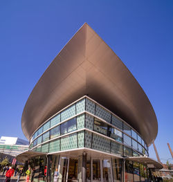 Low angle view of modern building against blue sky