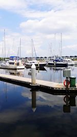 Sailboats moored at harbor